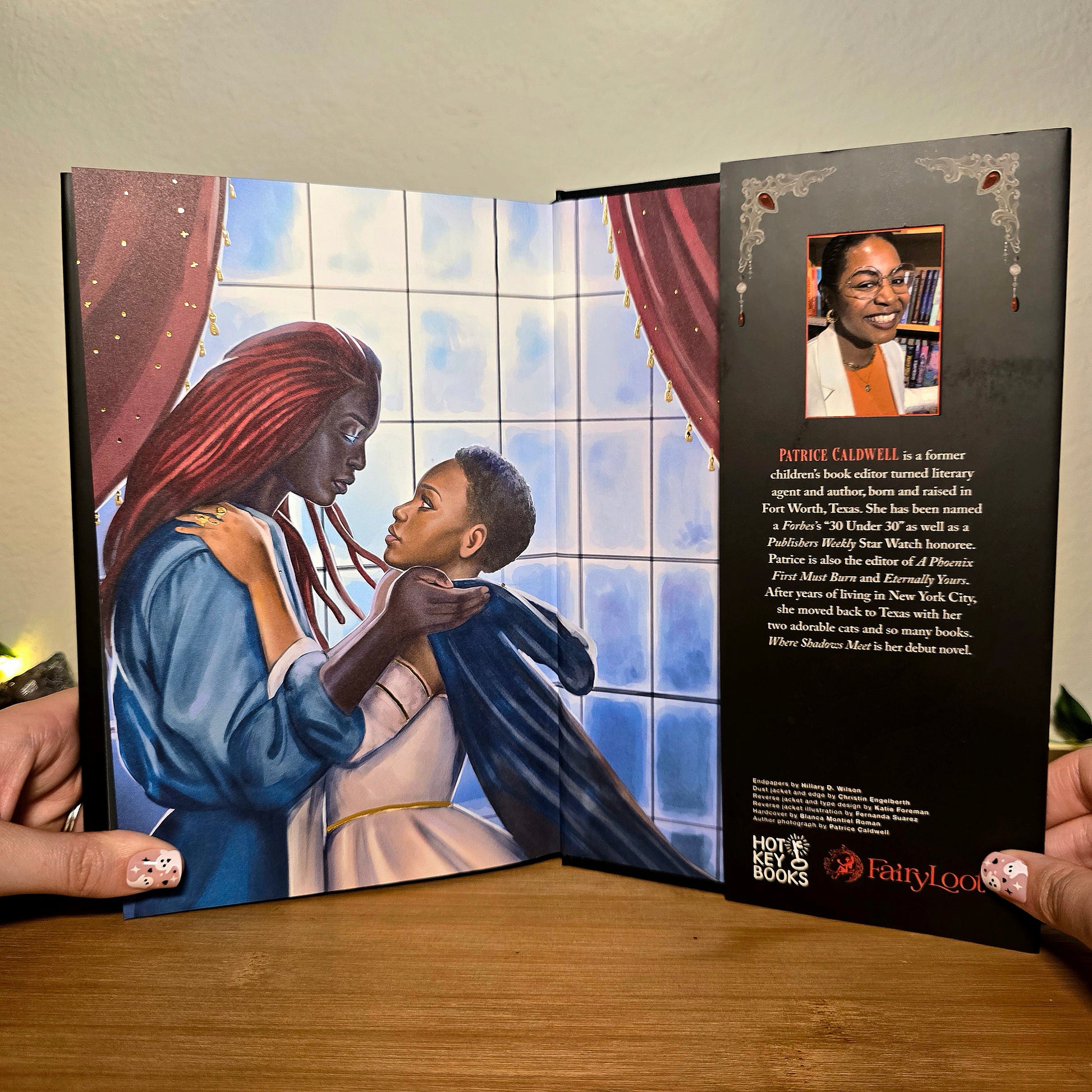 Open book with illustration of a woman and child, and text on a wooden surface.