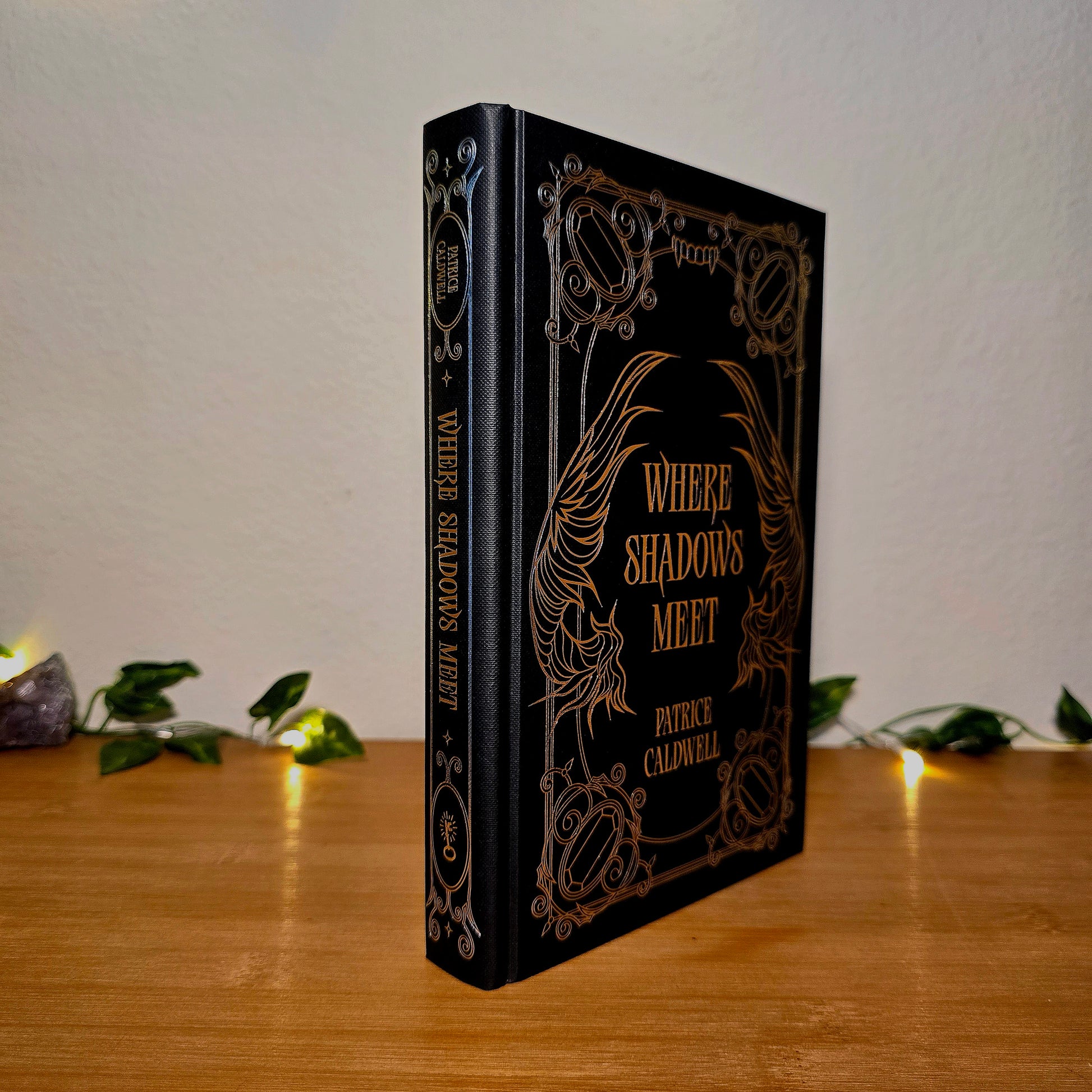 Decorative book titled 'Where Shadows Meet' on a wooden surface with a soft background