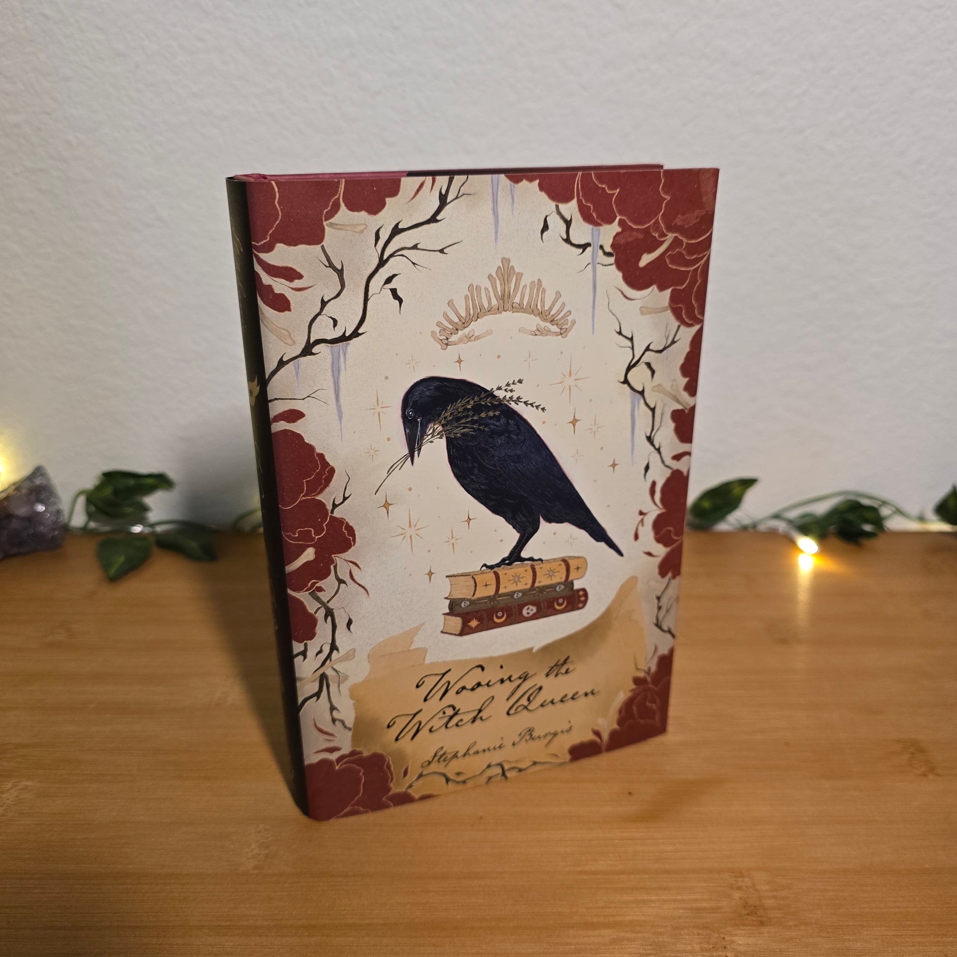 Decorative box with bird and floral design on a wooden surface