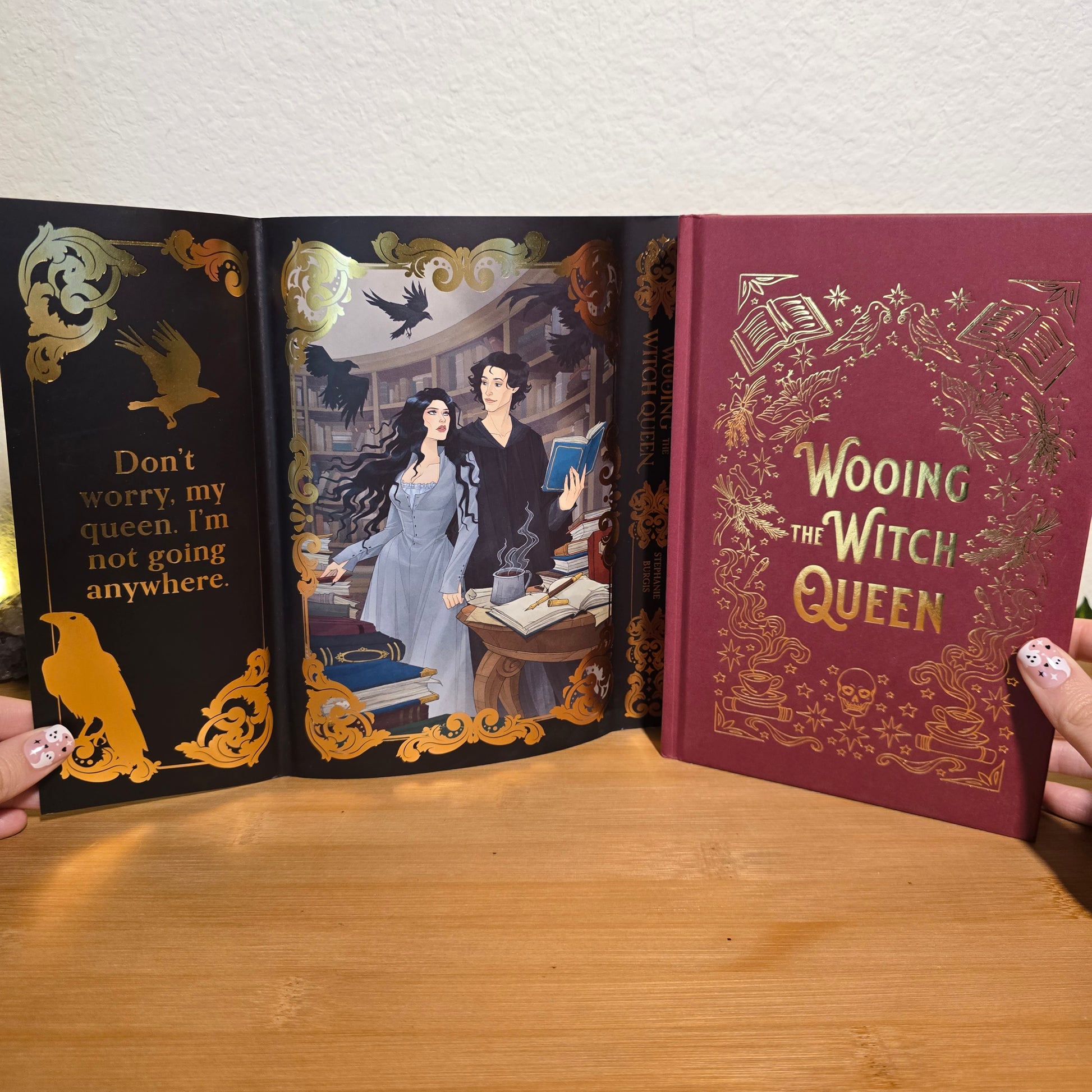 Book titled 'Wooing the Witch Queen' with decorative cover and interior pages.