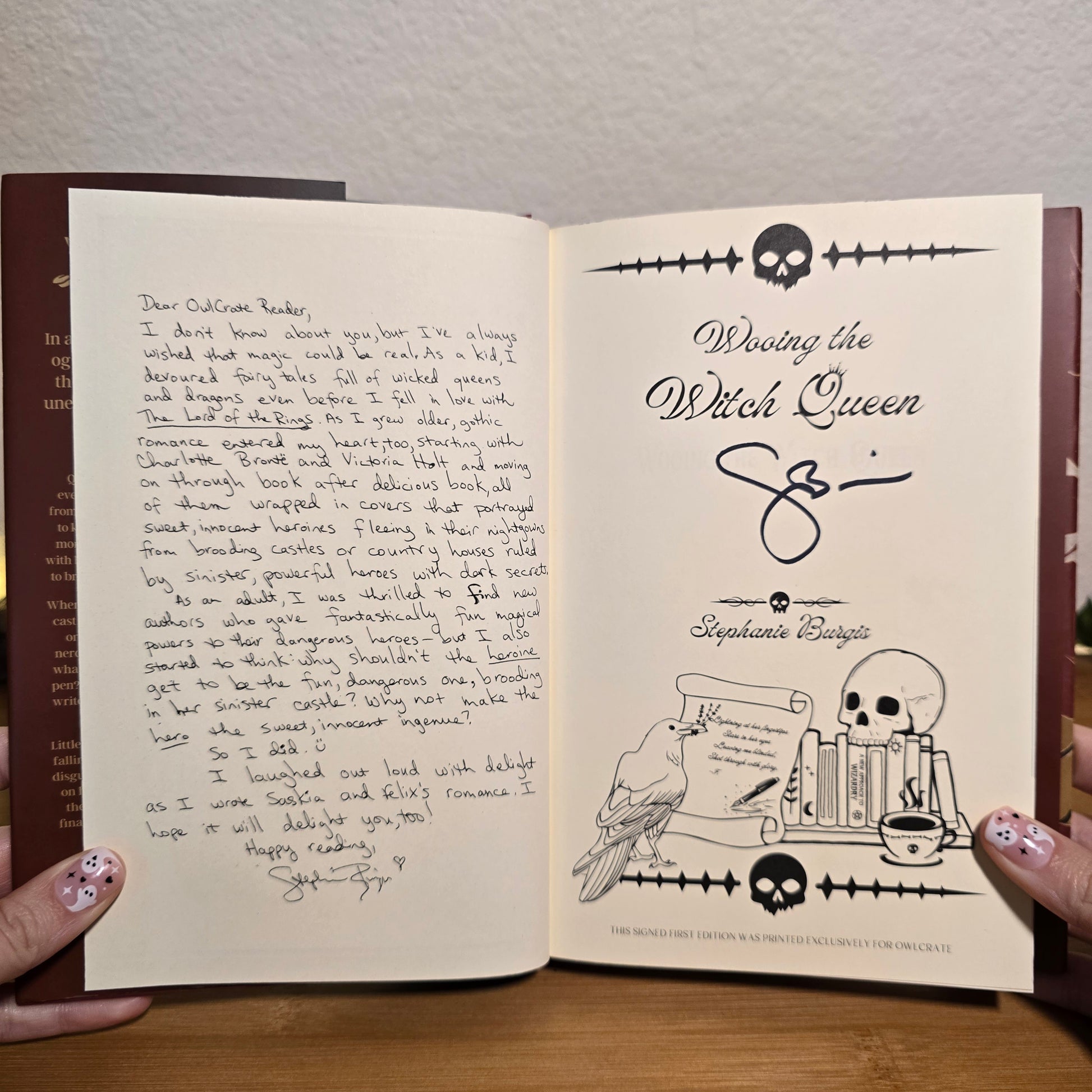 Open book with handwritten text and illustrations on a wooden surface